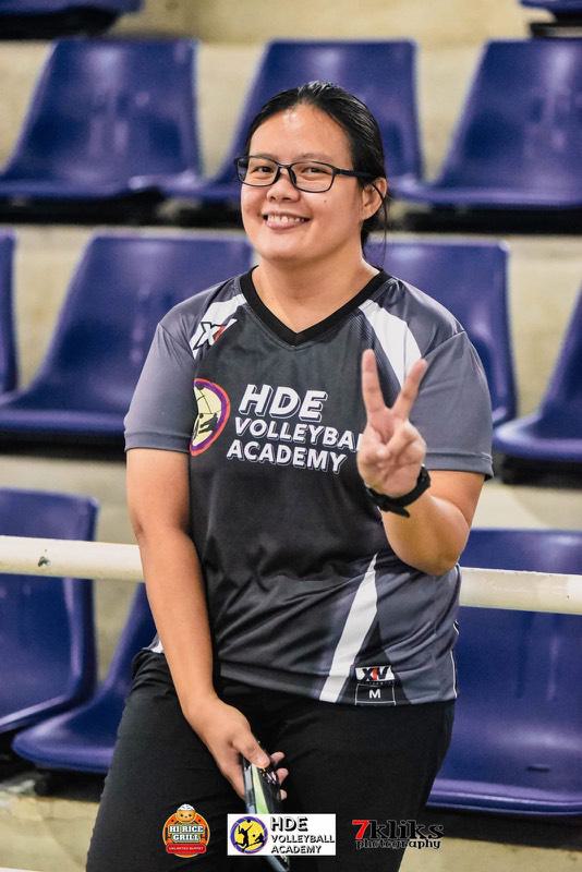 An HDE coach smiling courtside