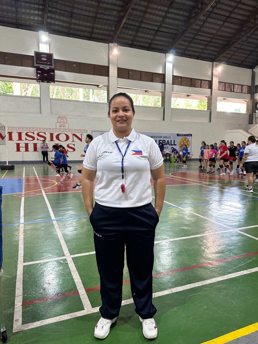 An HDE-trained referee in uniform at a school gym