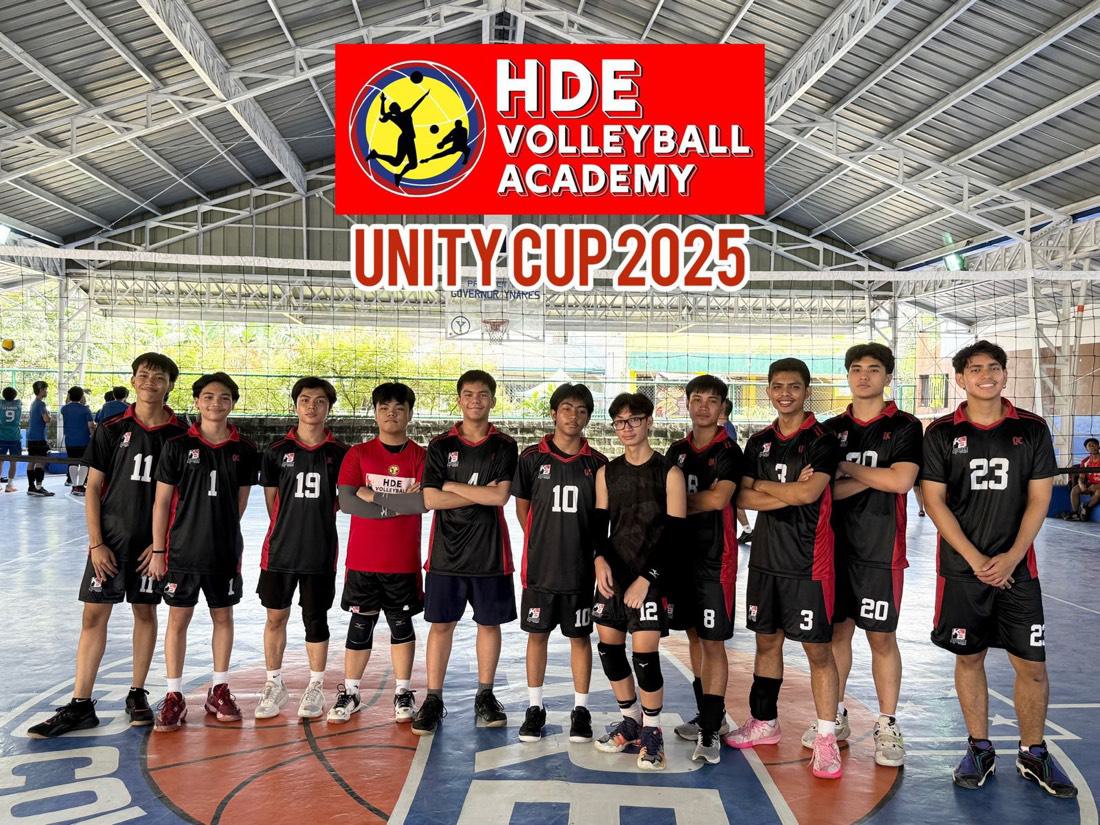 A boys team in black with the HDE Unity Cup 2025 banner